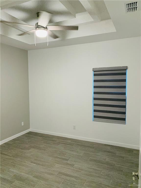 spare room featuring wood-type flooring and ceiling fan