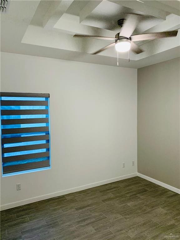 unfurnished room with ceiling fan, a raised ceiling, and dark wood-type flooring