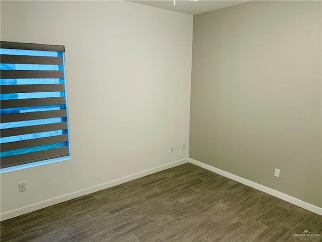 spare room featuring dark hardwood / wood-style floors