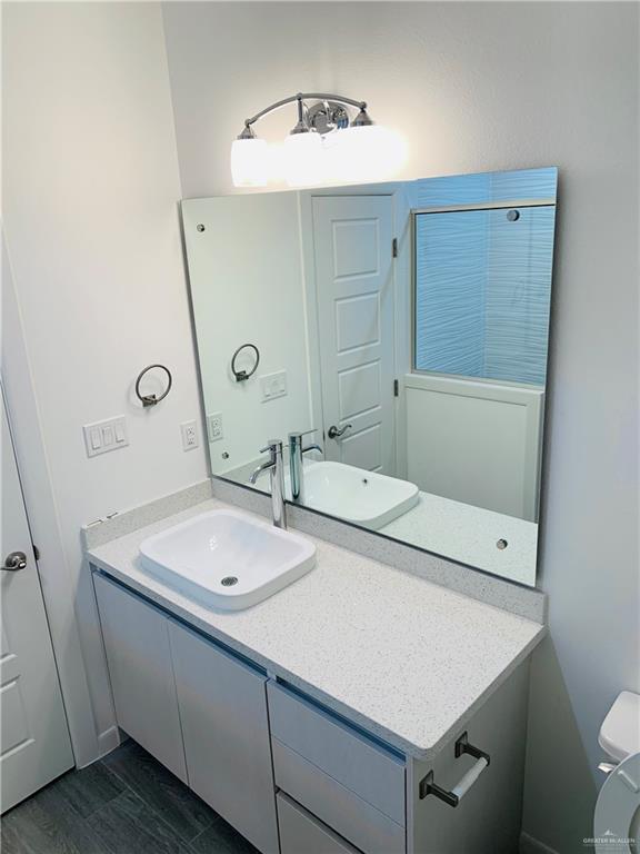 bathroom featuring vanity and toilet