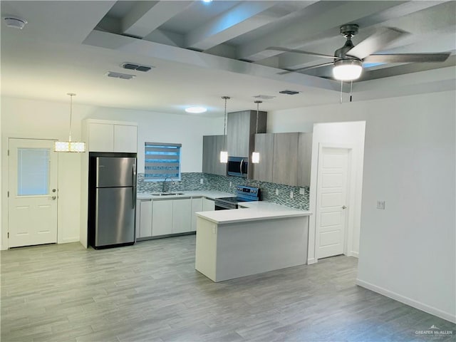 kitchen featuring decorative light fixtures, white cabinetry, stainless steel appliances, and light hardwood / wood-style flooring