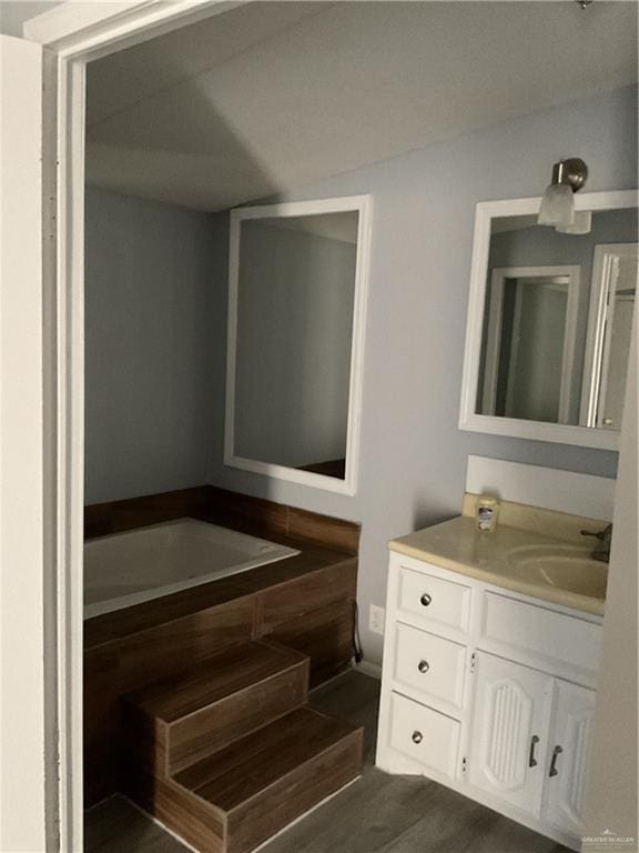 bathroom with vanity and wood finished floors