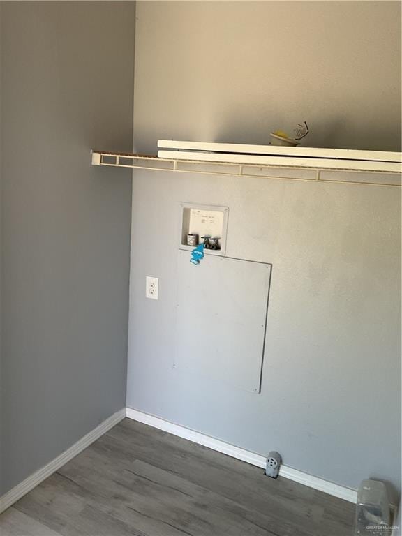 laundry area featuring laundry area, washer hookup, baseboards, and wood finished floors