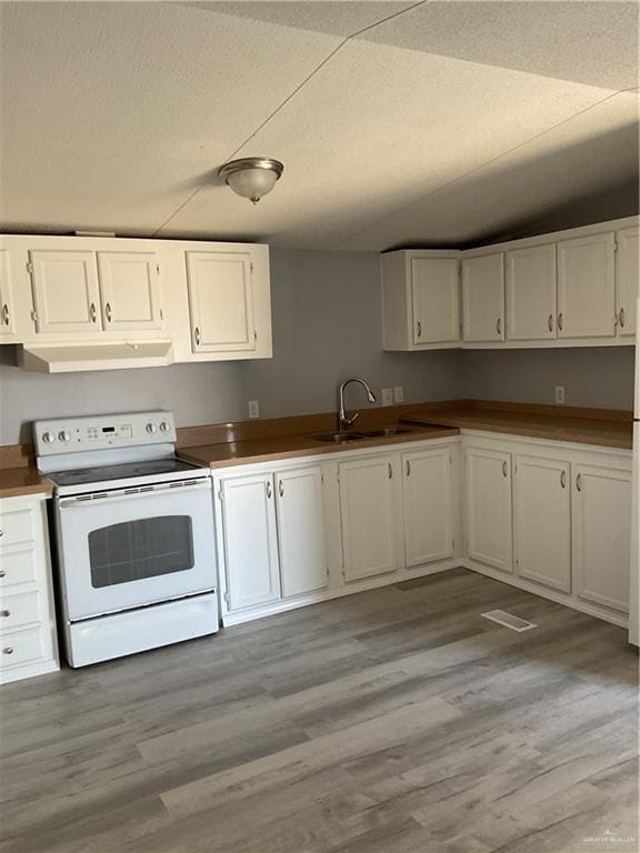 kitchen featuring under cabinet range hood, a textured ceiling, white electric range oven, white cabinetry, and light wood finished floors