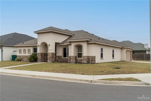 view of front facade featuring stucco siding, concrete driveway, an attached garage, a front yard, and stone siding