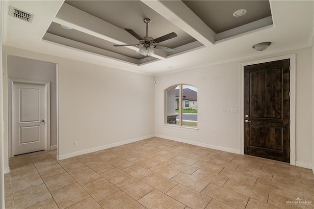 spare room with ceiling fan, visible vents, a raised ceiling, and baseboards