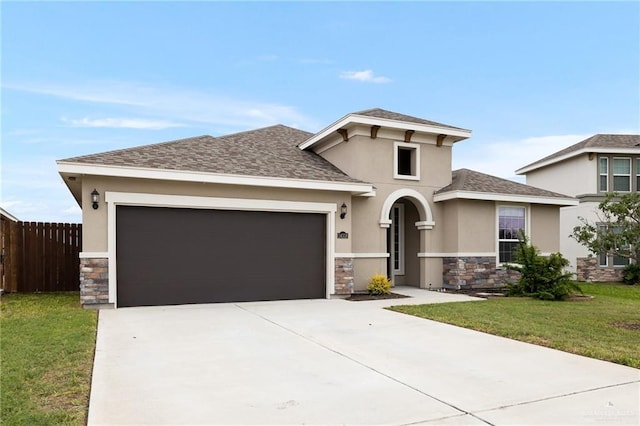 view of front of property with a garage and a front yard