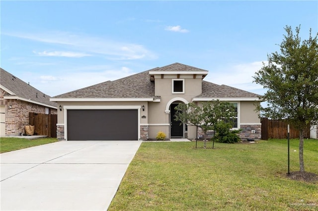 view of front of home featuring a garage and a front lawn