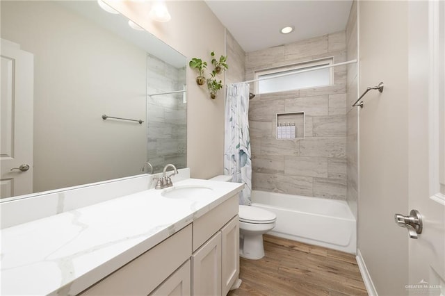 full bathroom with wood-type flooring, shower / bath combo, vanity, and toilet