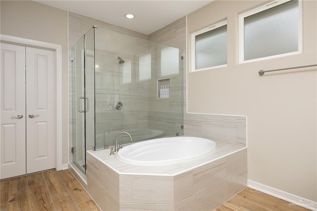 bathroom featuring shower with separate bathtub