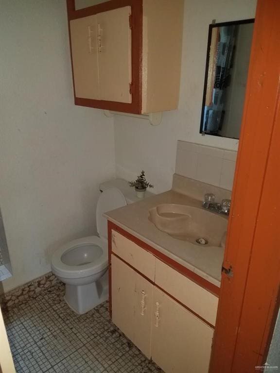 bathroom with tile patterned floors, vanity, and toilet