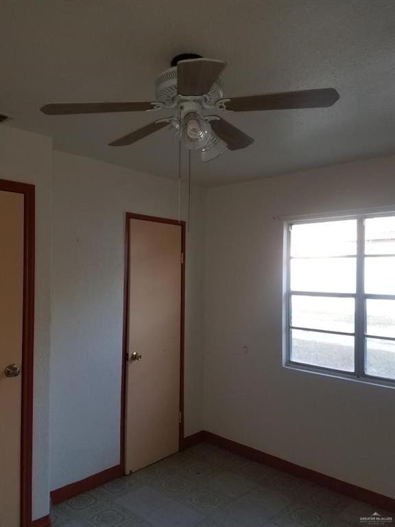 unfurnished room with ceiling fan