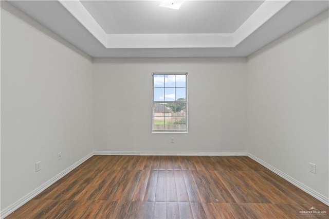 3017 Paradise Ave, Harlingen, TX 78552 - empty room featuring a tray ceiling and wood finished floors