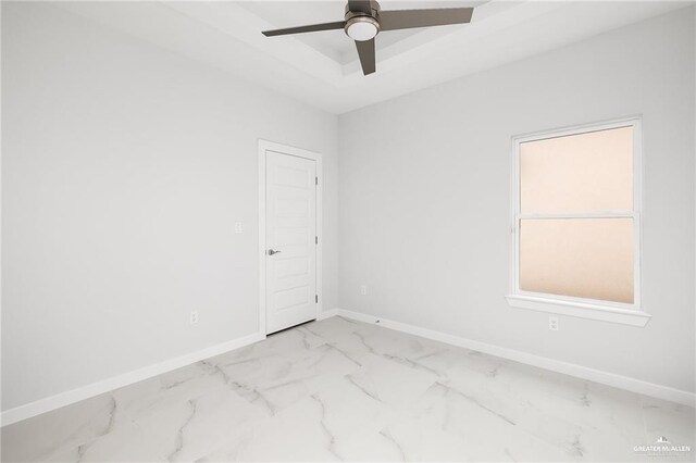 2805 Q St, Hidalgo, TX 78557 - empty room with a ceiling fan, marble finish floors, and a tray ceiling