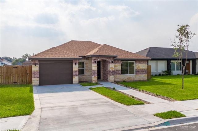 view of front of home featuring a front yard and a garage