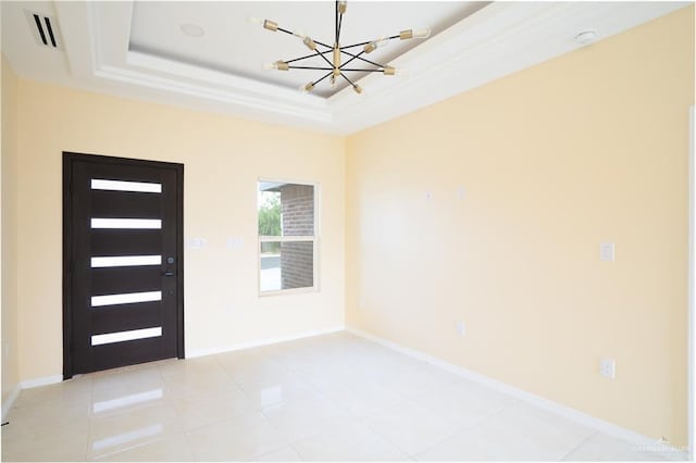 entrance foyer with a raised ceiling, light tile patterned floors, and a notable chandelier