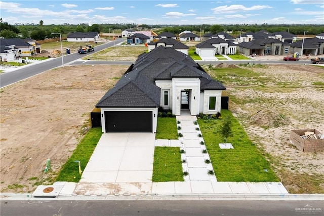 8104 N 51st St N, Mcallen, TX 78504 - french country inspired facade with an attached garage, a shingled roof, a residential view, and concrete driveway
