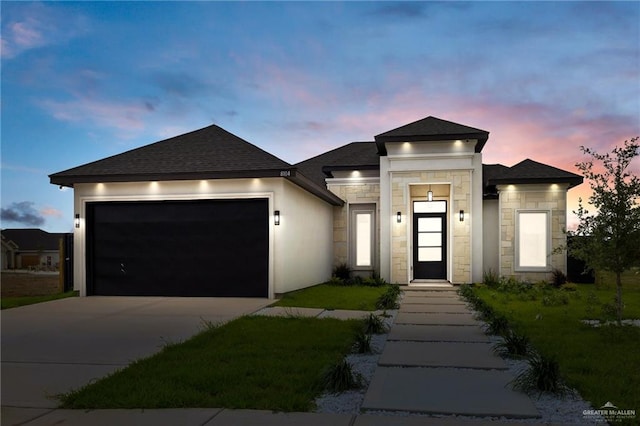 8104 N 51st St N, Mcallen, TX 78504 - prairie-style home with roof with shingles, an attached garage, concrete driveway, and stone siding