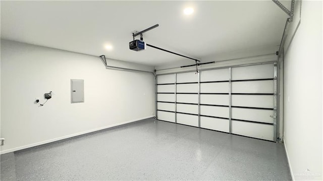 8104 N 51st St N, Mcallen, TX 78504 - garage featuring baseboards, a garage door opener, and electric panel