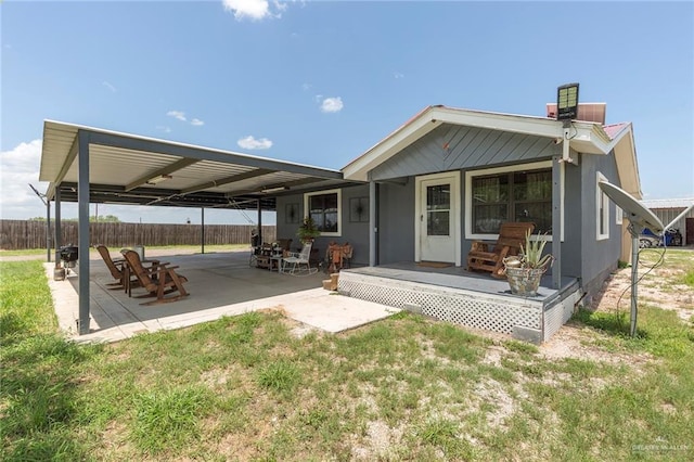 back of property featuring a yard, a porch, a patio, and fence