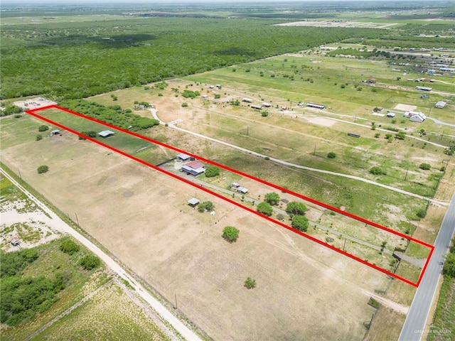 birds eye view of property with a rural view