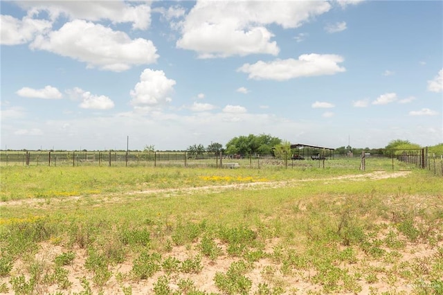 view of yard featuring fence and a rural view