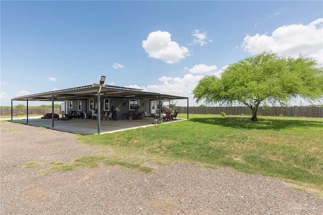 view of car parking featuring fence and a carport