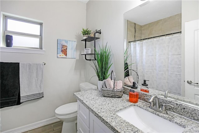 8718 Pink Flamingo St, Harlingen, TX 78552 - bathroom featuring vanity, toilet, baseboards, wood finished floors, and a shower with curtain