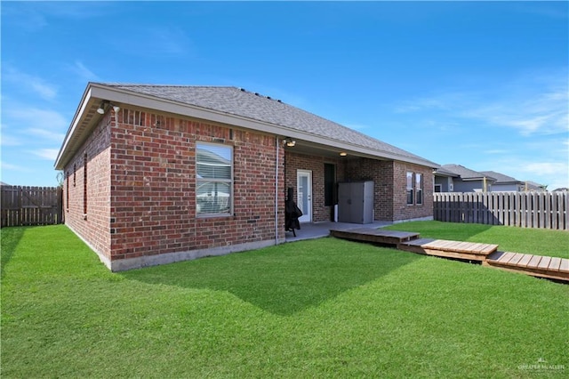 8718 Pink Flamingo St, Harlingen, TX 78552 - rear view of property featuring brick siding and a shingled roof