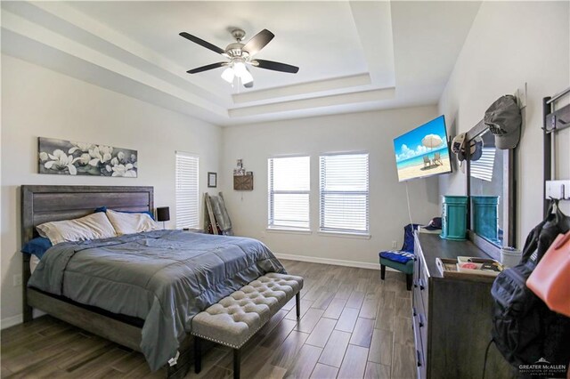 8718 Pink Flamingo St, Harlingen, TX 78552 - bedroom with a tray ceiling, dark wood-style flooring, baseboards, and a ceiling fan
