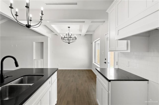 4216 Xenops Ave, Mcallen, TX 78504 - kitchen with a sink, a chandelier, dark wood-style flooring, beamed ceiling, and backsplash