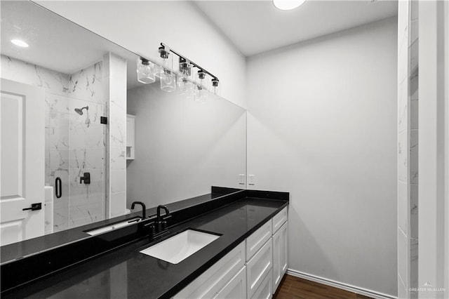 4216 Xenops Ave, Mcallen, TX 78504 - bathroom featuring a marble finish shower, vanity, wood finished floors, and baseboards