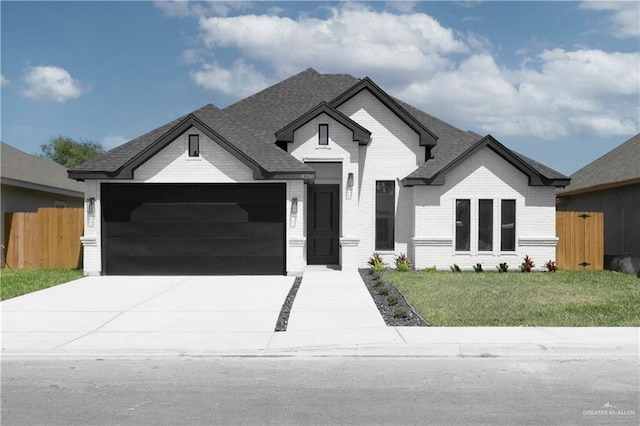 4216 Xenops Ave, Mcallen, TX 78504 - view of front facade with brick siding, a garage, concrete driveway, and roof with shingles