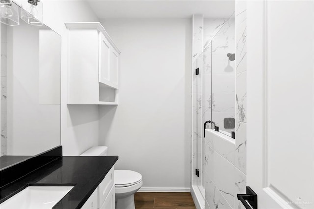 4216 Xenops Ave, Mcallen, TX 78504 - bathroom with vanity, a marble finish shower, toilet, wood finished floors, and baseboards