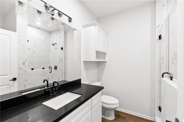 4216 Xenops Ave, Mcallen, TX 78504 - bathroom with a marble finish shower, toilet, vanity, wood finished floors, and baseboards