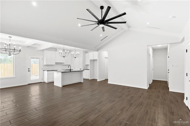 4216 Xenops Ave, Mcallen, TX 78504 - unfurnished living room featuring a chandelier, a sink, dark wood-style floors, and baseboards