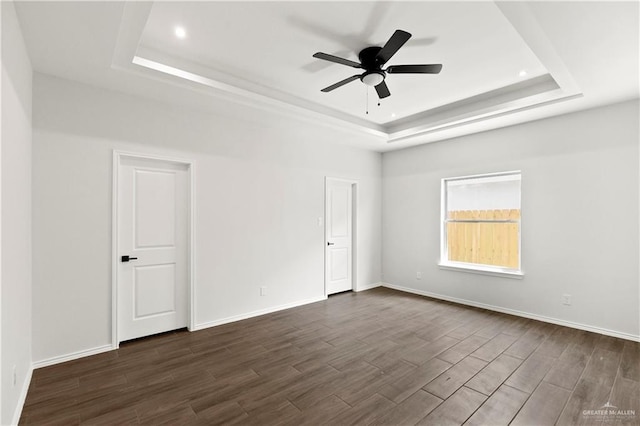4216 Xenops Ave, Mcallen, TX 78504 - empty room with a raised ceiling, ceiling fan, dark wood finished floors, recessed lighting, and baseboards