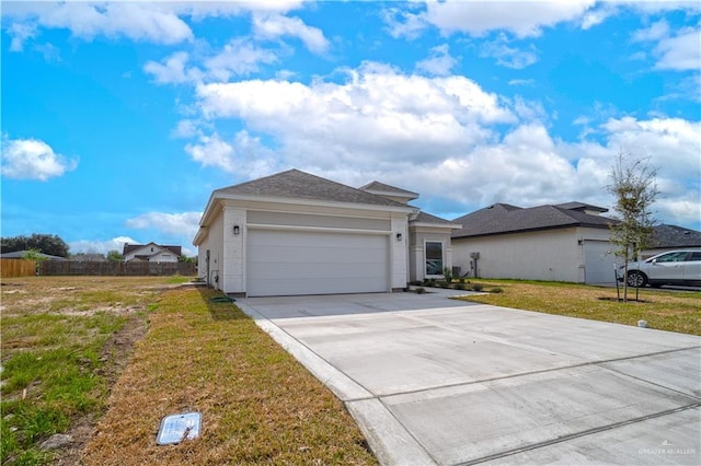 view of front of home featuring a garage and a front lawn