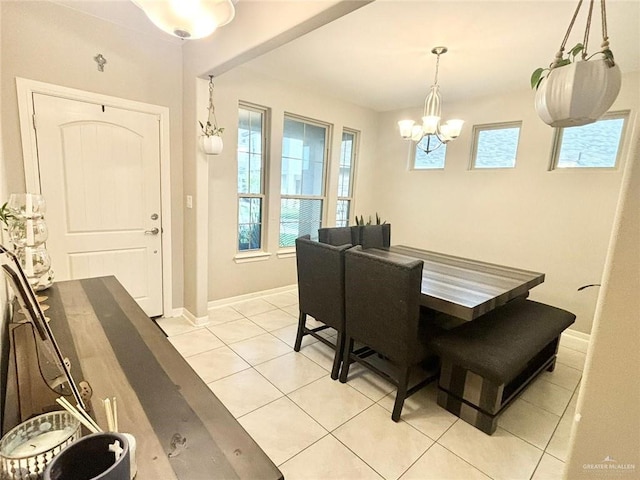 dining area with an inviting chandelier and light tile patterned flooring