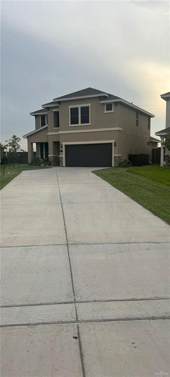 view of front of house featuring a front lawn and a garage