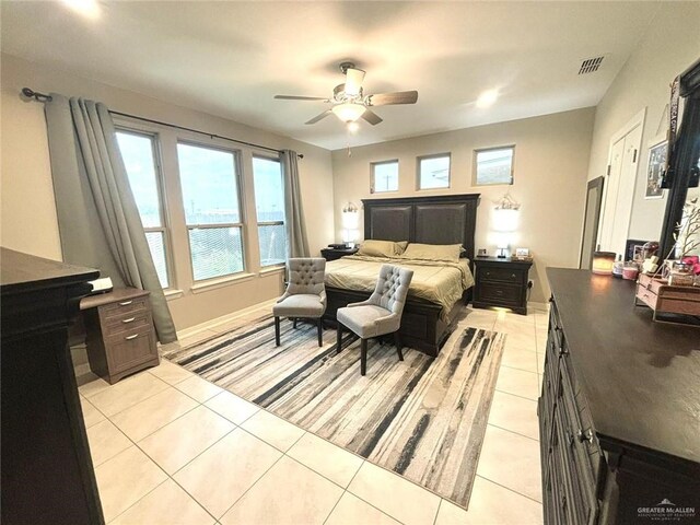 bedroom with ceiling fan and light tile patterned floors