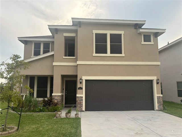 view of front of property featuring a garage and a front yard