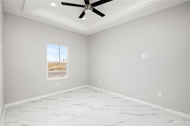 unfurnished room with a tray ceiling and ceiling fan