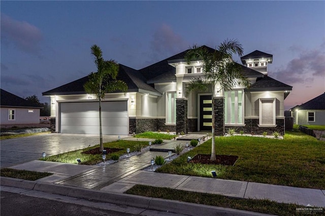 view of front of property featuring a lawn and a garage