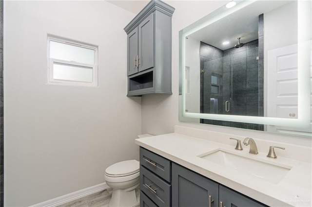 bathroom featuring wood-type flooring, vanity, toilet, and walk in shower