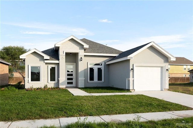 view of front of house with a front yard and a garage