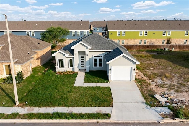 view of front of home featuring a garage and a front yard