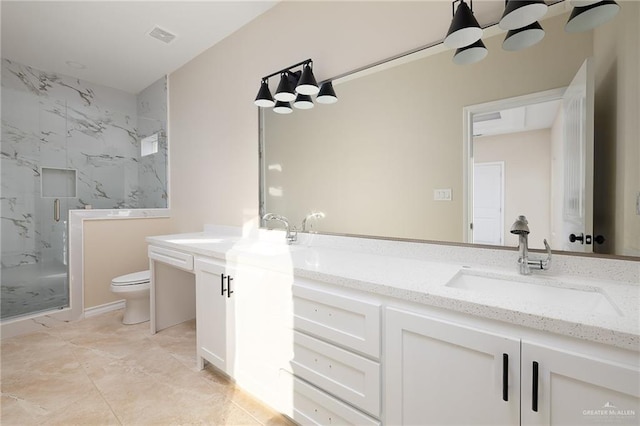 bathroom with toilet, vanity, and walk in shower