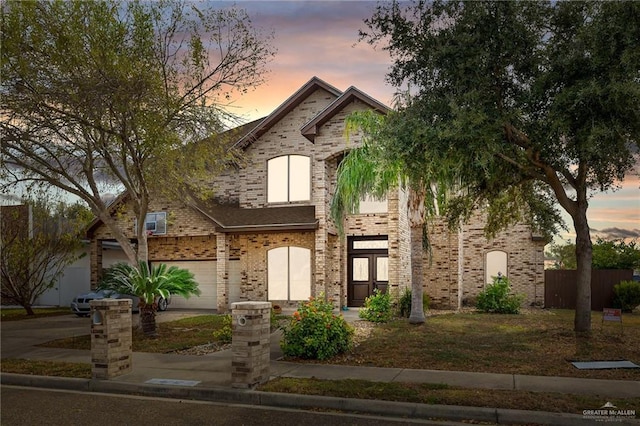 4717 Ebony Ave, Mcallen, TX 78501 - view of front of house with a garage, concrete driveway, and brick siding