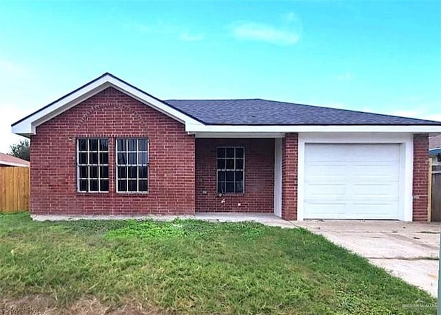 single story home with a garage and a front lawn